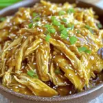 - Chicken and sauce essentials - 4 boneless, skinless chicken breasts - 1/2 cup honey - 1/4 cup soy sauce (or tamari for gluten-free) - 1/4 cup ketchup - 2 tablespoons grated fresh ginger - 4 cloves garlic, minced - 1 tablespoon cornstarch - 2 tablespoons sesame oil - 1/2 teaspoon black pepper - 1/2 teaspoon salt - Optional garnishes - Sesame seeds - Chopped green onions To make this dish, you need simple and fresh ingredients. The chicken breasts are the main star. Honey, soy sauce, and ketchup form a sweet and savory sauce. Fresh ginger and garlic add a nice kick. The sesame oil gives a rich flavor. Cornstarch helps thicken the sauce at the end. For a pop of color and taste, consider garnishing with sesame seeds and green onions. These toppings are optional but make the dish look nicer and bring extra flavor. If you want to learn how to make this dish, check out the Full Recipe for all details. Mixing the sauce Start by gathering a medium bowl. Add honey, soy sauce, ketchup, grated ginger, minced garlic, sesame oil, black pepper, and salt. Whisk all these ingredients together until smooth. This sauce is the heart of our dish. It brings sweet and savory flavors to the chicken. Preparing the chicken Next, take four boneless, skinless chicken breasts. Place them into the bottom of your crockpot. Pour the honey garlic sauce over the chicken. Make sure each piece is coated well. This helps the chicken absorb the flavors while cooking. Setting the crockpot Cover the crockpot with its lid. You can set it to low or high heat. For low, cook for 6 to 8 hours. If you’re in a hurry, cook on high for 3 to 4 hours. Cooking time details During cooking, the chicken will become tender and juicy. You can check it for doneness by ensuring it reaches an internal temperature of 165°F. Thickening the sauce When the chicken is done, take it out of the crockpot. Set it aside on a plate. In a small bowl, mix cornstarch with 2 tablespoons of water to make a slurry. Stir this mixture into the sauce left in the crockpot. Switch the crockpot to high and let the sauce thicken for about 10 to 15 minutes. Shredding and serving suggestions Once the sauce thickens, use two forks to shred the chicken. Return the shredded chicken to the sauce and mix well. Serve it hot, garnished with sesame seeds and chopped green onions. This adds a nice touch and a bit of crunch. Enjoy your meal! For the complete steps, check the Full Recipe. Marinating is key to great flavor. I always let the chicken soak in the honey garlic sauce for at least 30 minutes. This helps the chicken absorb all the flavors. You can even marinate it overnight for the best taste. Adjusting sweetness and saltiness is simple. If you like it sweeter, add more honey. For a saltier kick, increase the soy sauce. Just remember, balance is crucial for a delicious dish. To keep your chicken tender, use the low setting on your crockpot. This allows the chicken to cook slowly and stay juicy. If you're short on time, the high setting works too. Just ensure you don't overcook it. Using different crockpot settings can change the outcome. On low, cook for 6-8 hours, and on high, aim for 3-4 hours. Always check the chicken's internal temperature. It should reach 165°F (75°C) to be safe to eat. For more detailed cooking steps and a full ingredient list, check the Full Recipe. {{image_2}} You can change up the protein in this recipe. Try using chicken thighs instead of breasts. They add more flavor and stay juicy. If you want to go meatless, use tofu or tempeh. They soak up the honey garlic sauce well. For gluten-free options, use tamari instead of soy sauce. This keeps the dish safe for those with gluten issues. You can also lower the sugar by reducing the honey. Try using a sugar substitute like stevia if needed. This keeps the dish tasty but lighter. Adding vegetables can make this dish even better. You can toss in bell peppers, carrots, or broccoli. They add color and nutrients. Just cut them into small pieces and add them to the crockpot with the chicken. If you like heat, add some red pepper flakes or sriracha. This gives your honey garlic chicken a nice kick. You can also add fresh herbs like cilantro or basil. They brighten up the flavors and make it more aromatic. For the full recipe, check the main article. To keep your Crock Pot Honey Garlic Chicken fresh, follow these tips: - Refrigerating: Place leftovers in an airtight container. They can last for 3 to 4 days in the fridge. Make sure to let the chicken cool before sealing. - Freezing tips: For longer storage, freeze your chicken. Use a freezer-safe bag or container. It can last up to 3 months in the freezer. Just remember to label the bag with the date. When it’s time to enjoy your leftovers, use these methods for the best texture: - Microwave: Place the chicken in a microwave-safe dish. Heat on medium for about 2 to 3 minutes. Check and stir halfway through to heat evenly. - Stovetop: For a more even reheat, use a skillet. Heat over medium-low heat for about 5 to 7 minutes. Stir often to avoid sticking. - Oven: Preheat your oven to 350°F (175°C). Place the chicken in an oven-safe dish and cover with foil. Heat for about 15 to 20 minutes or until warm. Following these steps will help you enjoy your Crock Pot Honey Garlic Chicken even days later! For the complete recipe, check out the [Full Recipe]. Can I use frozen chicken? Yes, you can use frozen chicken. Just make sure to adjust the cooking time. If you cook on low, it may take an extra hour. For high, add about 30 minutes. This way, your chicken cooks safely and remains juicy. How do I know when the chicken is done? Check the chicken's temperature. It should reach 165°F. You can use a meat thermometer for this. The chicken will also look white and not pink inside. When you shred it, it should fall apart easily. Can I double the recipe? Yes, you can double the recipe. If you do, ensure your crockpot can hold the extra chicken. You may need to cook it a bit longer. Just keep an eye on the chicken’s temperature to ensure it cooks well. For the full recipe, check out [Full Recipe]. This blog post covered how to make tasty Honey Garlic Chicken in a crockpot. You learned about the key ingredients, preparation steps, and cooking methods. We explored simple tips for perfecting your dish, like marinating and adjusting flavors. I also shared variations to suit your taste and how to store tasty leftovers. In conclusion, this dish is easy and rewarding. With a little care, you can enjoy a meal that delights everyone. Happy cooking!